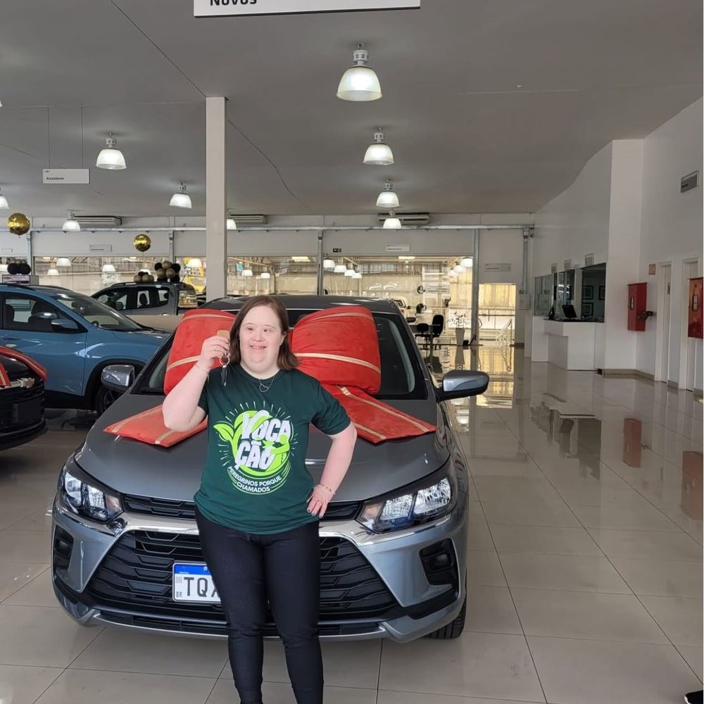 Cliente sorrindo com a chave do Chevrolet novo